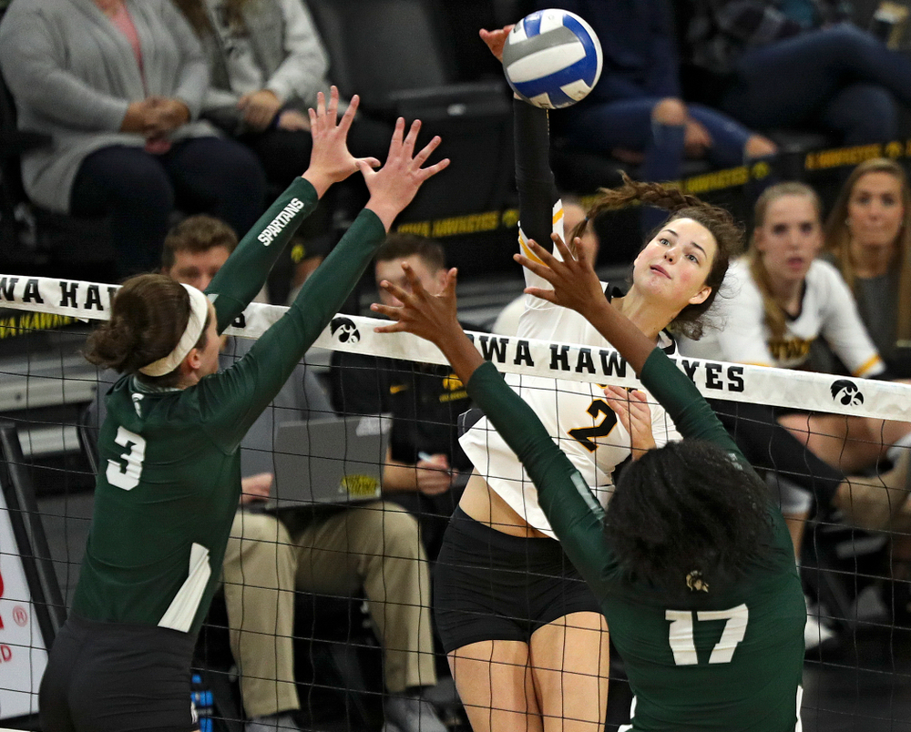 Iowa’s Courtney Buzzerio (2) sends over a kill during the first set of their volleyball match at Carver-Hawkeye Arena in Iowa City on Sunday, Oct 13, 2019. (Stephen Mally/hawkeyesports.com)
