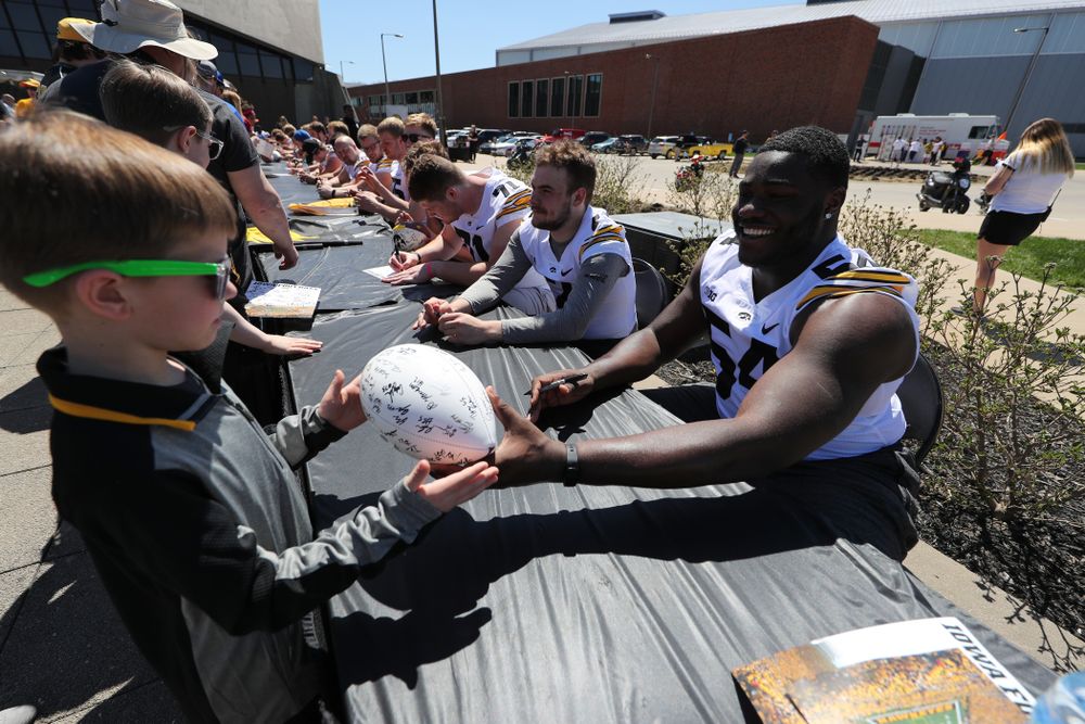 Members of the Iowa Football team sign autographs before the Iowa Hawkeyes game against the Nebraska Cornhuskers Saturday, April 20, 2019 at Duane Banks Field. (Brian Ray/hawkeyesports.com)