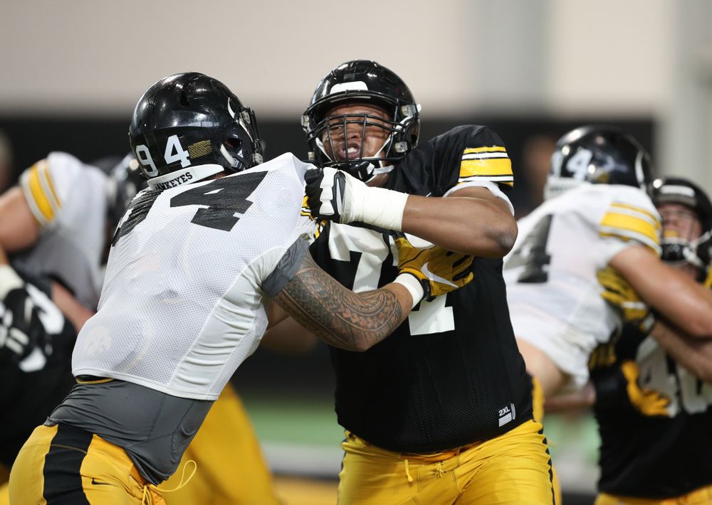 Iowa Hawkeyes defensive end A.J. Epenesa (94) and offensive lineman Alaric Jackson (77) uring Fall Camp Practice No. 6 Thursday, August 8, 2019 at the Ronald D. and Margaret L. Kenyon Football Practice Facility. (Brian Ray/hawkeyesports.com)