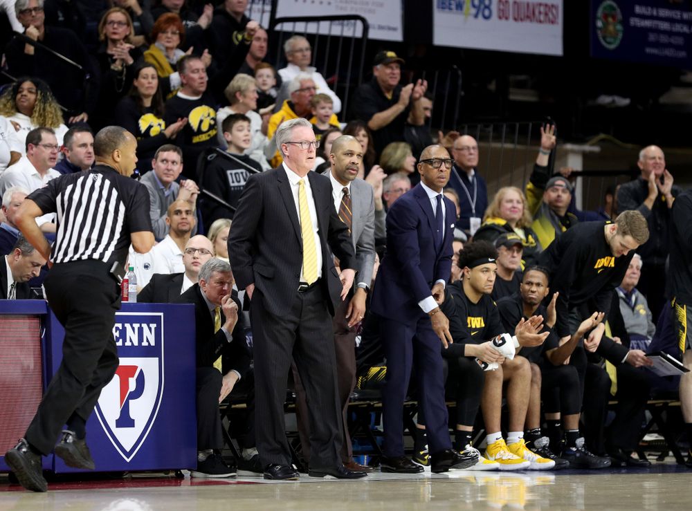 Iowa Hawkeyes head coach Fran McCaffery, assistant coach Billy Taylor, and assistant coach Sherman Dillard against Penn State Saturday, January 4, 2020 at the Palestra in Philadelphia. (Brian Ray/hawkeyesports.com)