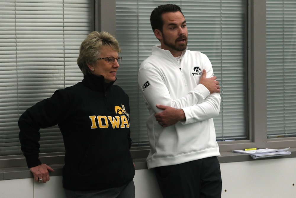 Iowa Hawkeyes Head Coach Ross Wilson talks with Deputy Athletics Director Barbara Burke before their match against the Butler Bulldogs Sunday, January 27, 2019 at the Hawkeye Tennis and Recreation Complex. (Brian Ray/hawkeyesports.com)