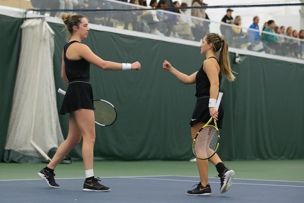 Iowa’s Samantha Mannix and Danielle Burich bump fists during doubles during the Iowa women’s tennis meet vs UNI on Saturday, February 29, 2020 at the Hawkeye Tennis and Recreation Complex. (Lily Smith/hawkeyesports.com)
