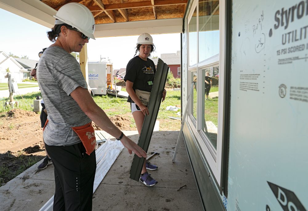 Iowa assistant coach Abby Stamp (from left) and McKenna Warnock work on a Habitat for Humanity Women Build project in Iowa City on Wednesday, Sep 25, 2019. (Stephen Mally/hawkeyesports.com)