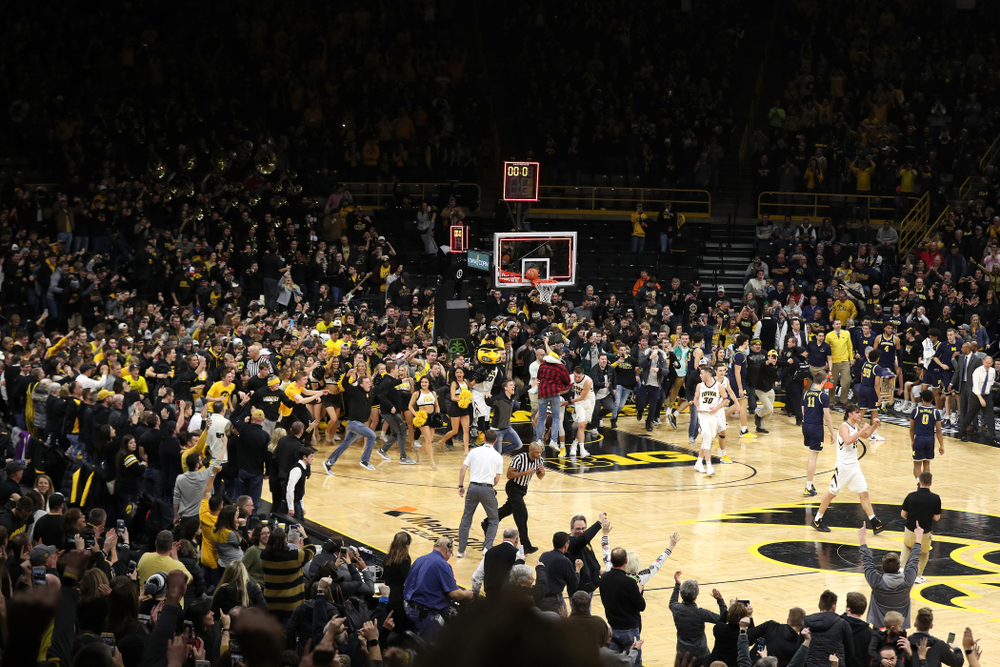 Fans storm the court after Iowa Hawkeyes defeated the Michigan Wolverines Friday, February 1, 2019 at Carver-Hawkeye Arena. (Brian Ray/hawkeyesports.com)