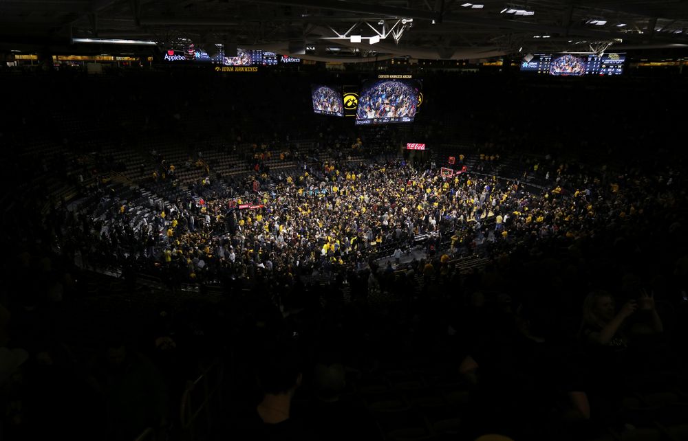 Fans storm the court after Iowa Hawkeyes defeated the Michigan Wolverines Friday, February 1, 2019 at Carver-Hawkeye Arena. (Brian Ray/hawkeyesports.com)