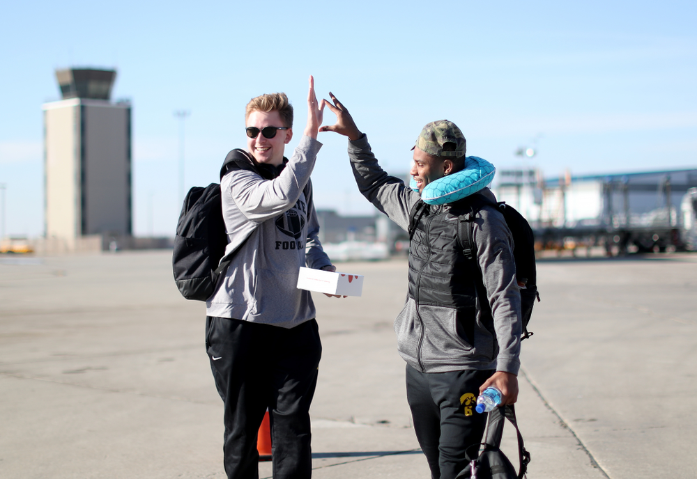 Iowa Hawkeyes quarterback Spencer Petras (7) and wide receiver Ihmir Smith-Marsette (6) board the team plane at the Eastern Iowa Airport Saturday, December 21, 2019 on the way to San Diego, CA for the Holiday Bowl. (Brian Ray/hawkeyesports.com)