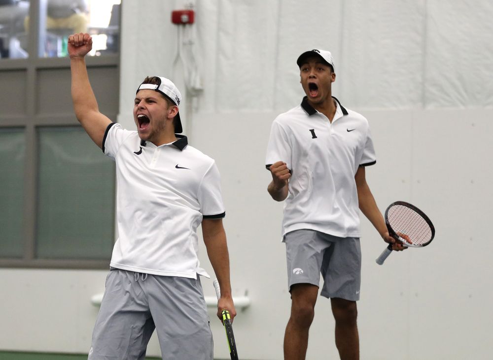 Iowa's Will Davies and Oliver Okonkwo celebrate after winning a doubles match against Western Michigan Saturday, January 19, 2019 at the Hawkeye Tennis and Recreation Complex. (Brian Ray/hawkeyesports.com)