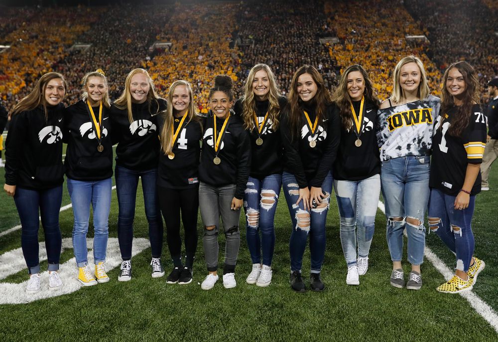 Members of the Iowa softball team are recognized by the Presidential Committee on Athletics at halftime during a game against Wisconsin on September 22, 2018. (Tork Mason/hawkeyesports.com)