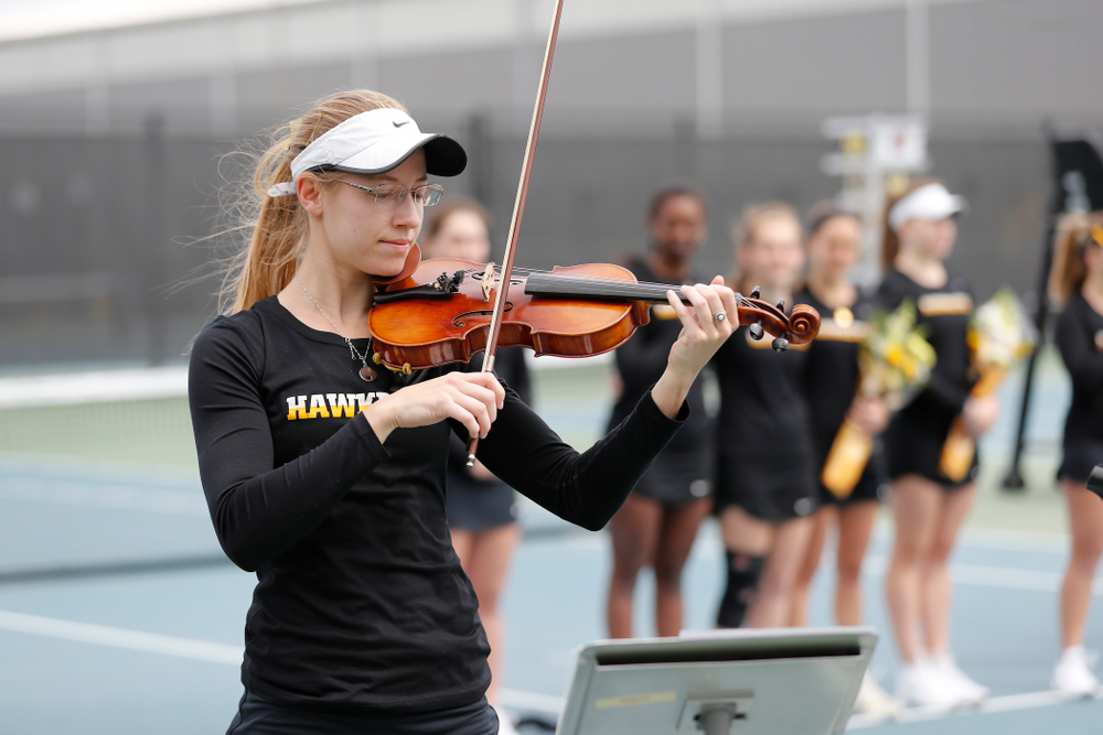 Iowa senior Montana Crawford plays the National Anthem before their match against the Wisconsin Badgers Sunday, April 22, 2018 at the Hawkeye Tennis and Recreation Center. (Brian Ray/hawkeyesports.com)