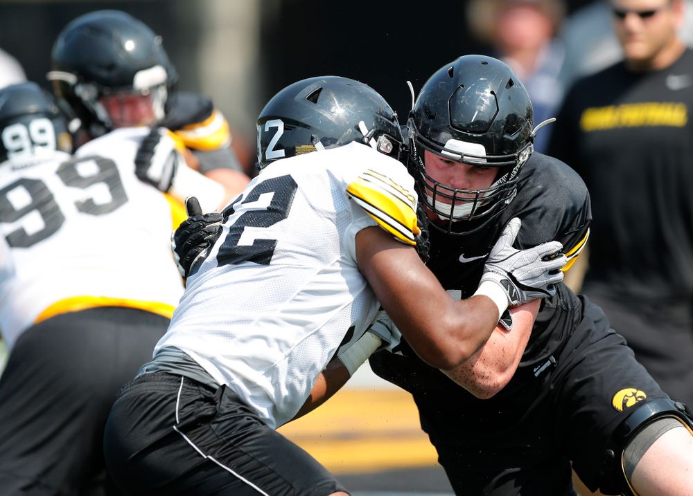 Iowa Hawkeyes offensive lineman Mark Kallenberger (71) and linebacker Djimon Colbert (32) during fall camp practice No. 9 Friday, August 10, 2018 at the Kenyon Practice Facility. (Brian Ray/hawkeyesports.com)