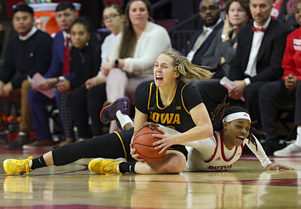 Iowa guard Kathleen Doyle (22) grabs a loose ball on the court during the fourth quarter of their game at the Rutgers Athletic Center in Piscataway, N.J. on Sunday, March 1, 2020. (Stephen Mally/hawkeyesports.com)