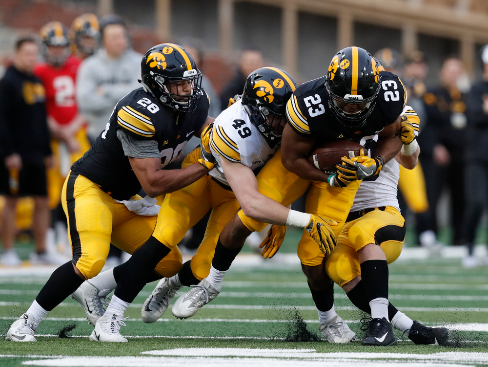 Iowa Hawkeyes wide receiver Dominique Dafney (23) and linebacker Nick Niemann (49) during the final spring practice Friday, April 20, 2018 at Kinnick Stadium. (Brian Ray/hawkeyesports.com)