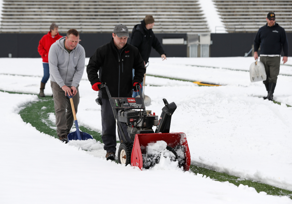 Members of the Iowa Athletics Turf Management staff create the #SnowWave for kids in the Stead Family Children's Hospital Thursday, February