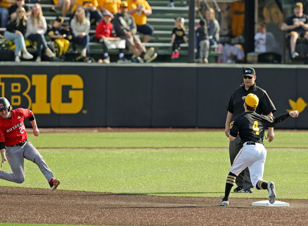 Iowa Hawkeyes second baseman Mitchell Boe (4) throws to first base as they turn a double play during the eighth inning of their game against Rutgers at Duane Banks Field in Iowa City on Saturday, Apr. 6, 2019. (Stephen Mally/hawkeyesports.com)
