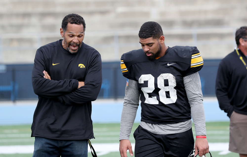 Former Hawkeye Football player Quinn Early talks with running back Toren Young (28) following Holiday Bowl Practice No. 3 Tuesday, December 24, 2019 at San Diego Mesa College. (Brian Ray/hawkeyesports.com)