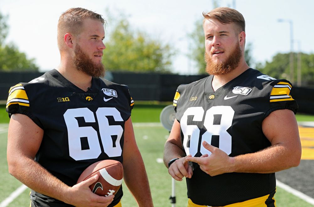 Iowa Hawkeyes offensive lineman Levi Paulsen (66) and offensive lineman Landan Paulsen (68) talk during Iowa Football Media Day at the Hansen Football Performance Center in Iowa City on Friday, Aug 9, 2019. (Stephen Mally/hawkeyesports.com)