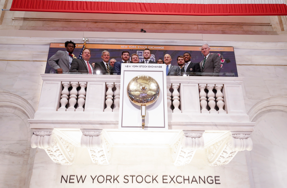 Iowa Hawkeyes linebacker Josey Jewell (43), defensive back Joshua Jackson (15), offensive lineman Sean Welsh (79) and head coach Kirk Ferentz ring the opening bell at the New York Stock Exchange Tuesday, December 26, 2017 in New York. (Brian Ray/hawkeyesports.com)