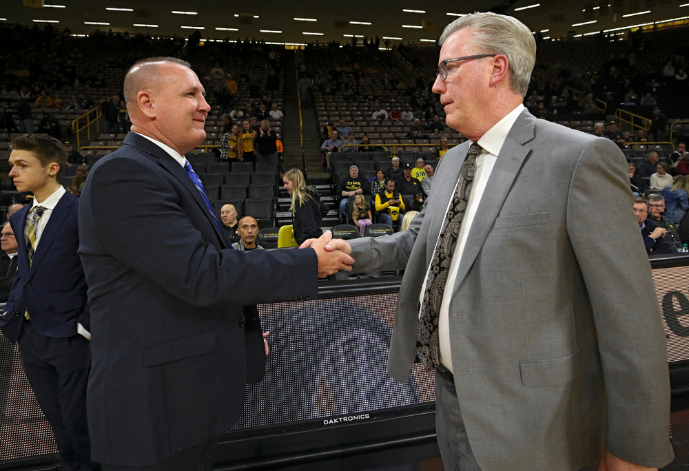Lindsey Wilson College head coach Keith Adkins (from left) shakes hands with Iowa Hawkeyes head coach Fran McCaffery before their exhibition game against Lindsey Wilson College at Carver-Hawkeye Arena in Iowa City on Monday, Nov 4, 2019. (Stephen Mally/hawkeyesports.com)