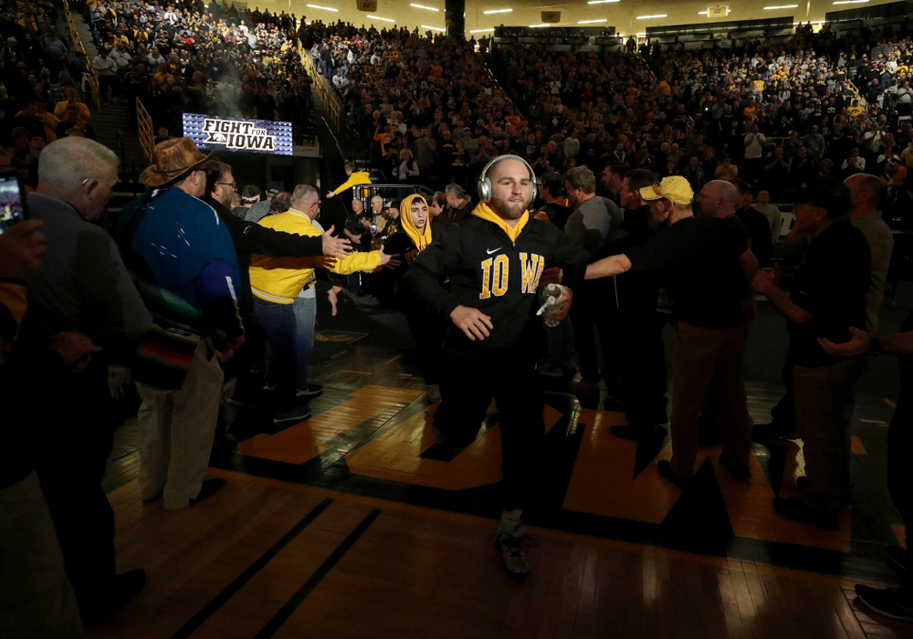 Alex Marinelli runs through the alumni tunnel before the Iowa Hawkeyes meet against Oklahoma State’s at pounds Sunday, February 23, 2020 at Carver-Hawkeye Arena. (Brian Ray/hawkeyesports.com)