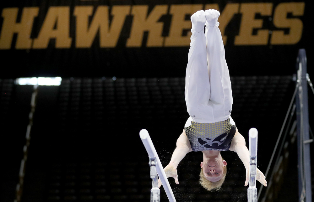 Iowa’s Nick Merryman competes on the parallel bars against Illinois Sunday, March 1, 2020 at Carver-Hawkeye Arena. (Brian Ray/hawkeyesports.com)
