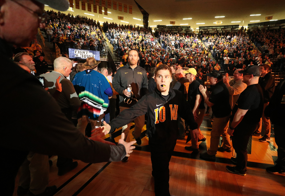 Spencer Lee slaps hands in the alumni tunnel before the Iowa Hawkeyes meet against Oklahoma State’s at pounds Sunday, February 23, 2020 at Carver-Hawkeye Arena. (Brian Ray/hawkeyesports.com)