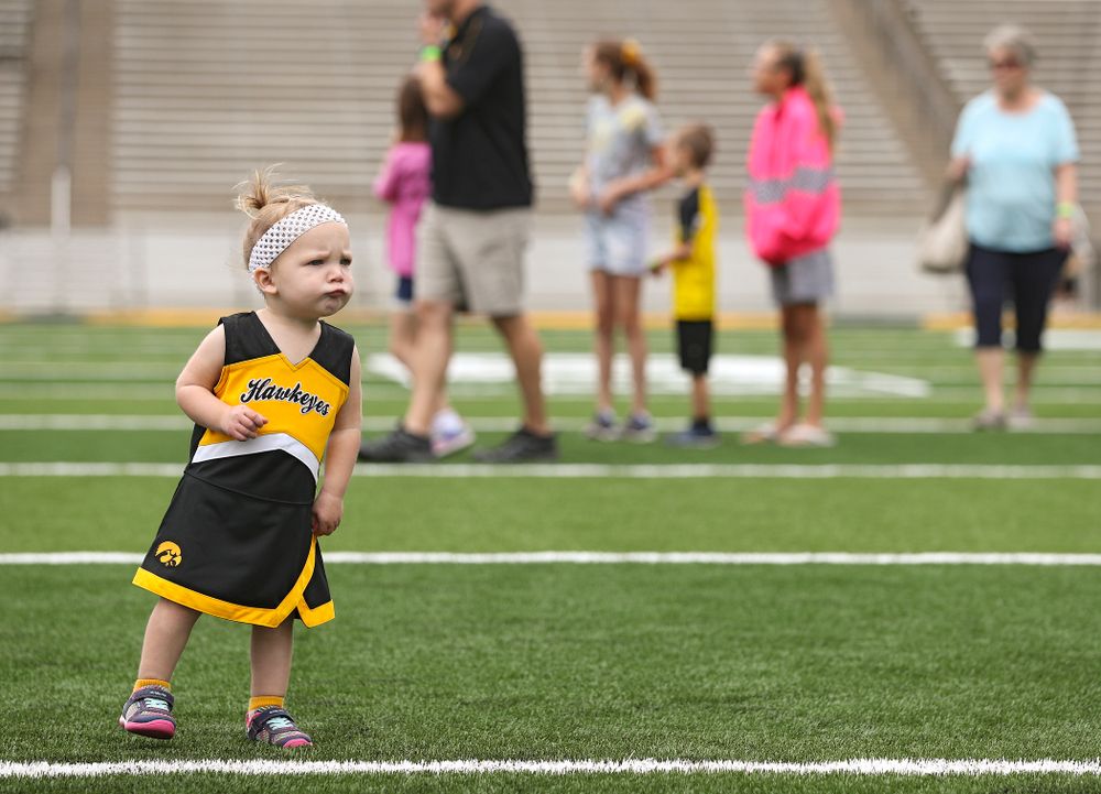 A young fan walks on the field as Junior Hawk Club members participate in the Swarm Experience during Kids Day at Kinnick Stadium in Iowa City on Saturday, Aug 10, 2019. (Stephen Mally/hawkeyesports.com)