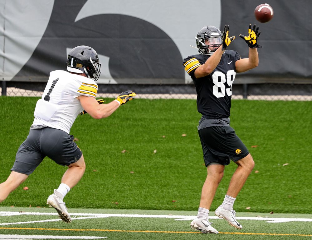 Iowa Hawkeyes wide receiver Nico Ragaini (89) pulls in a pass as defensive back Wes Dvorak (1) closes in during Fall Camp Practice No. 15 at the Hansen Football Performance Center in Iowa City on Monday, Aug 19, 2019. (Stephen Mally/hawkeyesports.com)