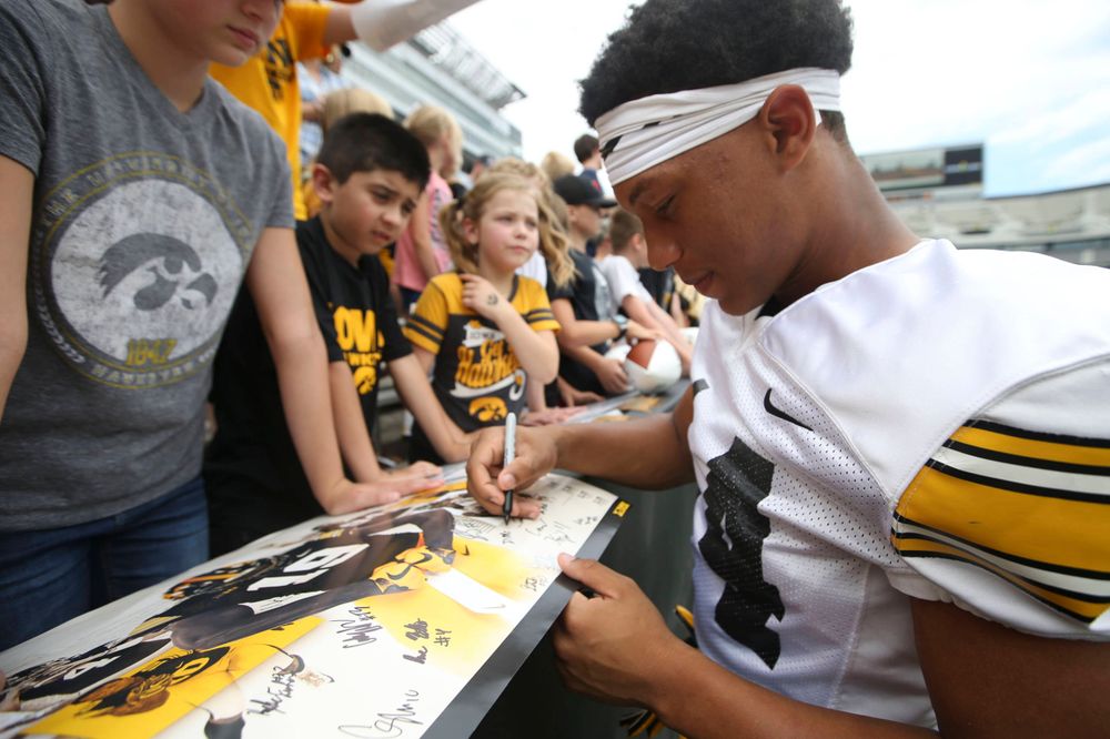 Iowa Hawkeyes defensive back Daraun McKinney (14) signs autographs during Kids Day at Kinnick Stadium on Saturday, August 10, 2019. (Lily Smith/hawkeyesports.com)