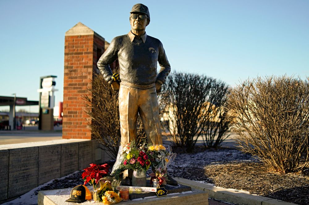 A memorial at the base of the Hayden Fry statue in Coralville on Wednesday, December 18, 2019. Hayden Fry passed away on Dec. 17, at the age of 90. (Stephen Mally/hawkeyesports.com)