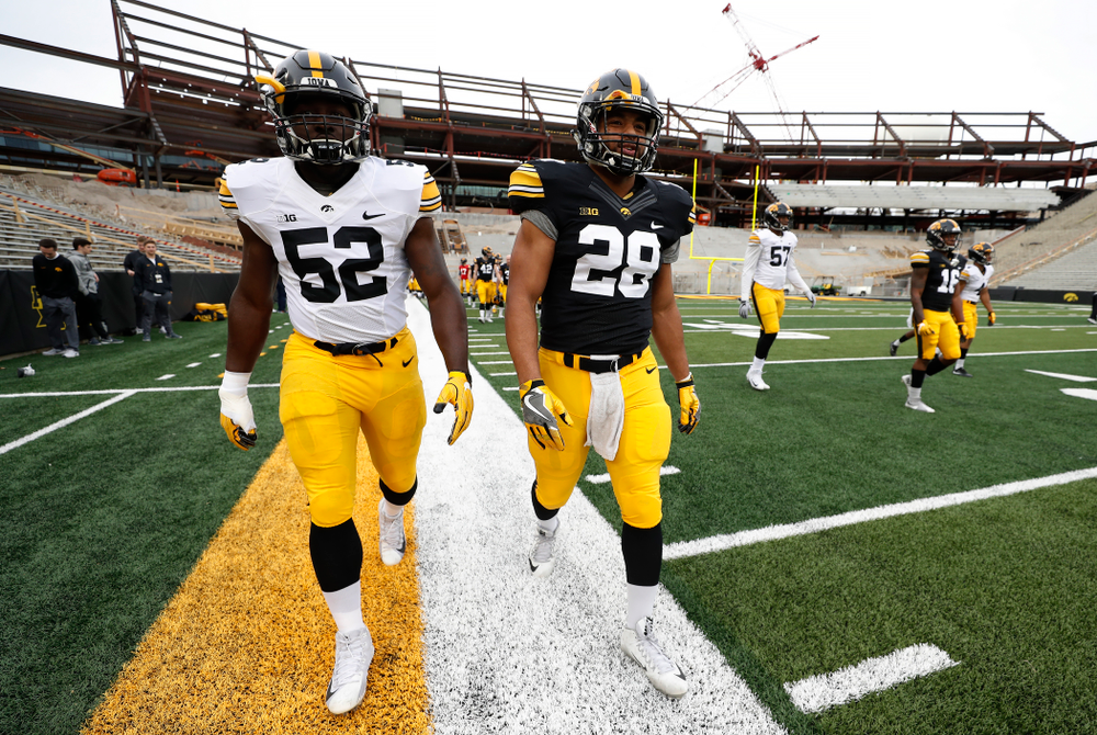 Iowa Hawkeyes linebacker Amani Jones (52) and running back Toren Young (28) during the final spring practice Friday, April 20, 2018 at Kinnick Stadium. (Brian Ray/hawkeyesports.com)