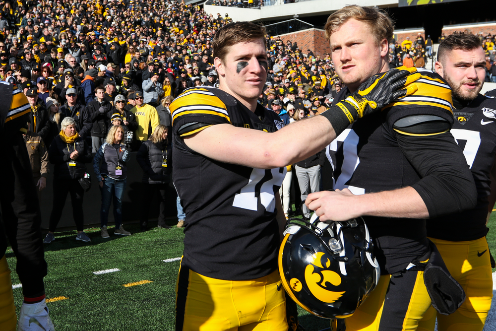 Iowa Hawkeyes defensive back John Milani (18) and Iowa Hawkeyes punter Michael Sleep-Dalton (22) during Iowa football vs Illinois on Saturday, November 23, 2019 at Kinnick Stadium. (Lily Smith/hawkeyesports.com)