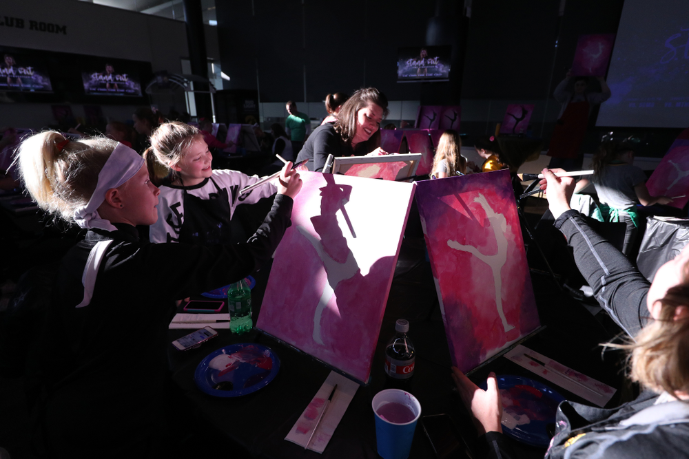 Fans of the GymHawks paint a gymnast with Brush and Barrel before the Iowa Hawkeyes meet against the Minnesota Golden Gophers Saturday, January 19, 2019 at Carver-Hawkeye Arena. (Brian Ray/hawkeyesports.com)