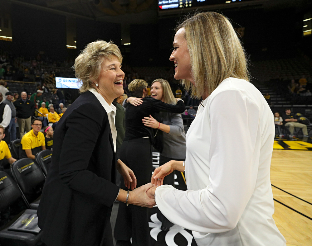 Iowa Hawkeyes head coach Lisa Bluder talks with Drake Bulldogs head coach Jennie Baranczyk before their game at Carver-Hawkeye Arena in Iowa City on Saturday, December 21, 2019. (Stephen Mally/hawkeyesports.com)