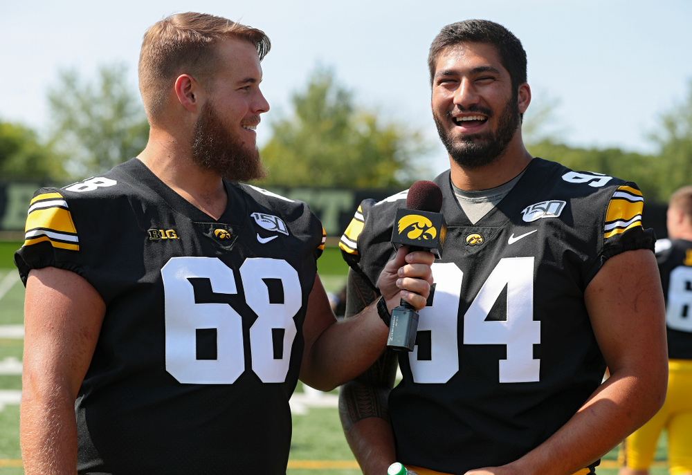 Iowa Hawkeyes offensive lineman Landan Paulsen (68) interviews defensive end A.J. Epenesa (94) during Iowa Football Media Day at the Hansen Football Performance Center in Iowa City on Friday, Aug 9, 2019. (Stephen Mally/hawkeyesports.com)