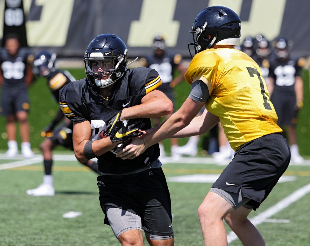 Iowa Hawkeyes wide receiver Nico Ragaini (89) takes a handoff from quarterback Spencer Petras (7) during Fall Camp Practice No. 7 at the Hansen Football Performance Center in Iowa City on Friday, Aug 9, 2019. (Stephen Mally/hawkeyesports.com)