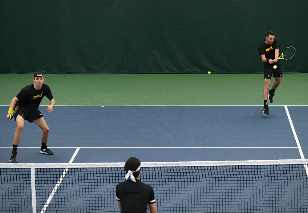 Iowa’s Kareem Allaf (right) returns a shot as Nikita Snezhko (left) look son during their doubles match at the Hawkeye Tennis and Recreation Complex in Iowa City on Friday, March 6, 2020. (Stephen Mally/hawkeyesports.com)