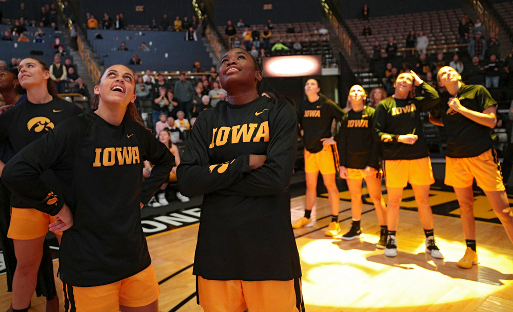 Iowa guard Gabbie Marshall (24) and guard Tomi Taiwo (1) watch the video board before their game against Winona State at Carver-Hawkeye Arena in Iowa City on Sunday, Nov 3, 2019. (Stephen Mally/hawkeyesports.com)