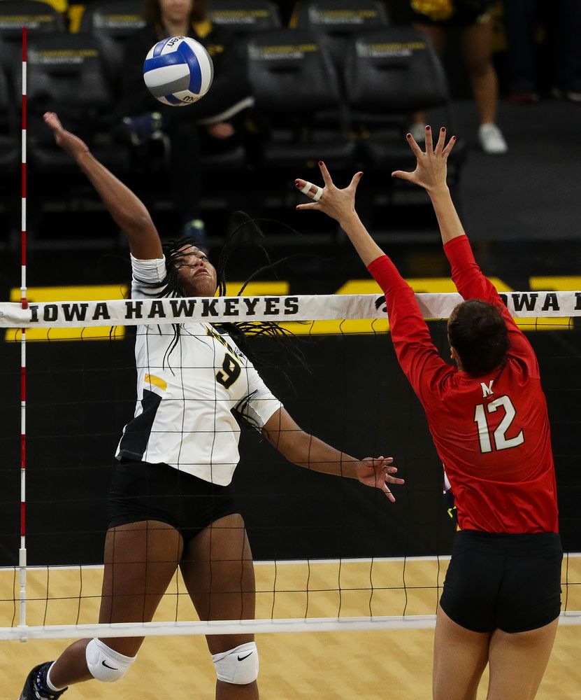 Iowa Hawkeyes middle blocker Amiya Jones (9) spikes the ball during a match against Maryland at Carver-Hawkeye Arena on November 23, 2018. (Tork Mason/hawkeyesports.com)