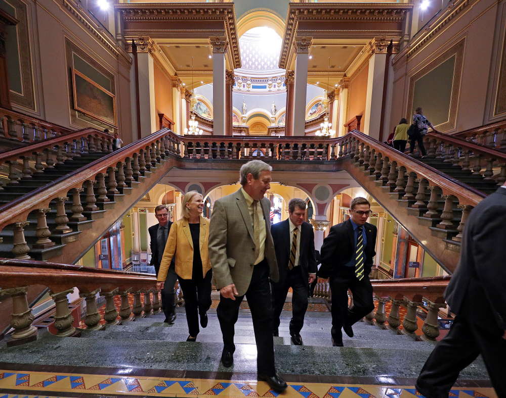Iowa's Spencer Lee (right) walks up the stairs with Mary Harreld (from left), Bruce Harreld, University of Iowa President, and head coach Tom Brands before being honored at the Iowa State Capitol Building on Tuesday, Apr. 9, 2019. (Stephen Mally/hawkeyesports.com)