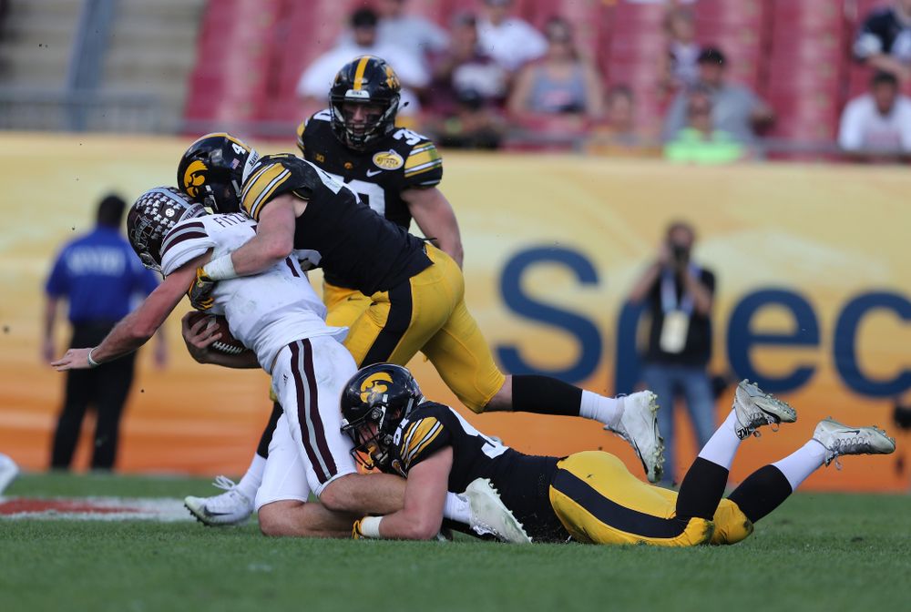 Iowa Hawkeyes defensive lineman Brady Reiff (91) and linebacker Nick Niemann (49) during the Outback Bowl Tuesday, January 1, 2019 at Raymond James Stadium in Tampa, FL. (Brian Ray/hawkeyesports.com)