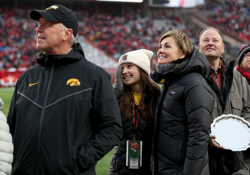 Iowa hero Katie Gudenkauf stands with Iowa Governor Kim Reynolds and Henry B. and Patricia B. Tippie Director of Athletics Chair Gary Barta as she is honored at half-time of the Iowa Hawkeyes game against the Nebraska Cornhuskers Friday, November 29, 2019 at Memorial Stadium in Lincoln, Neb. (Brian Ray/hawkeyesports.com)