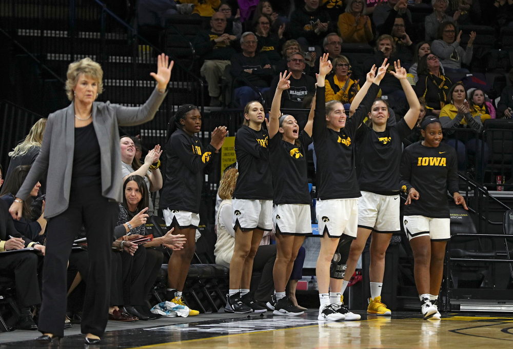 The Iowa bench celebrates after a 3-pointer during the first quarter of their game at Carver-Hawkeye Arena in Iowa City on Sunday, January 12, 2020. (Stephen Mally/hawkeyesports.com)
