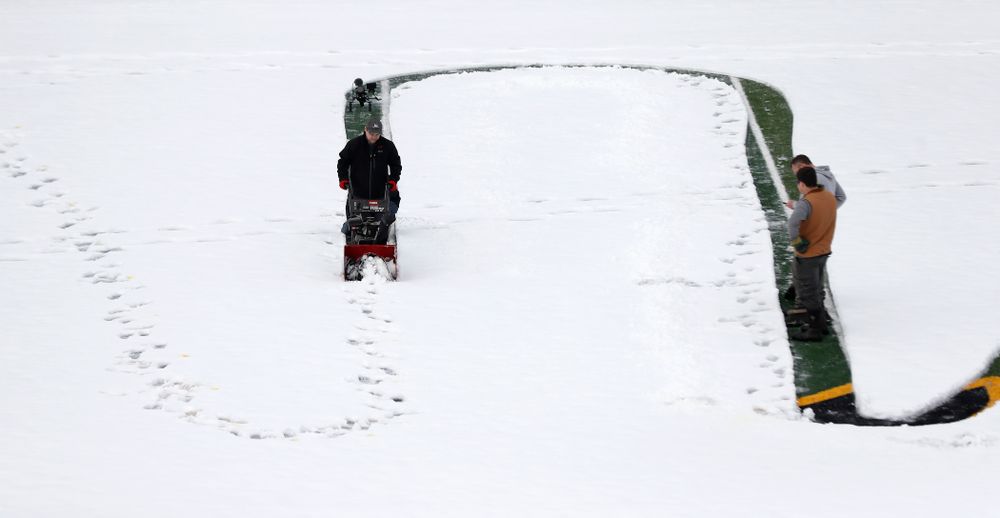 Members of the Iowa Athletics Turf Management staff create the #SnowWave for kids in the Stead Family Children's Hospital Thursday, February