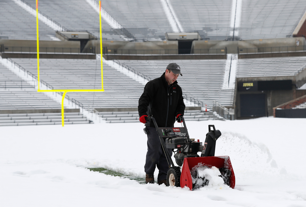 Members of the Iowa Athletics Turf Management staff create the #SnowWave for kids in the Stead Family Children's Hospital Thursday, February