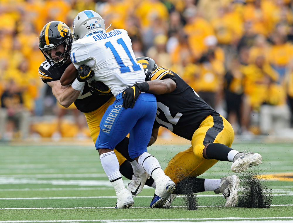 Iowa Hawkeyes defensive back Jack Koerner (28) and Iowa Hawkeyes linebacker Djimon Colbert (32) make a hit during third quarter of their game at Kinnick Stadium in Iowa City on Saturday, Sep 28, 2019. (Stephen Mally/hawkeyesports.com)