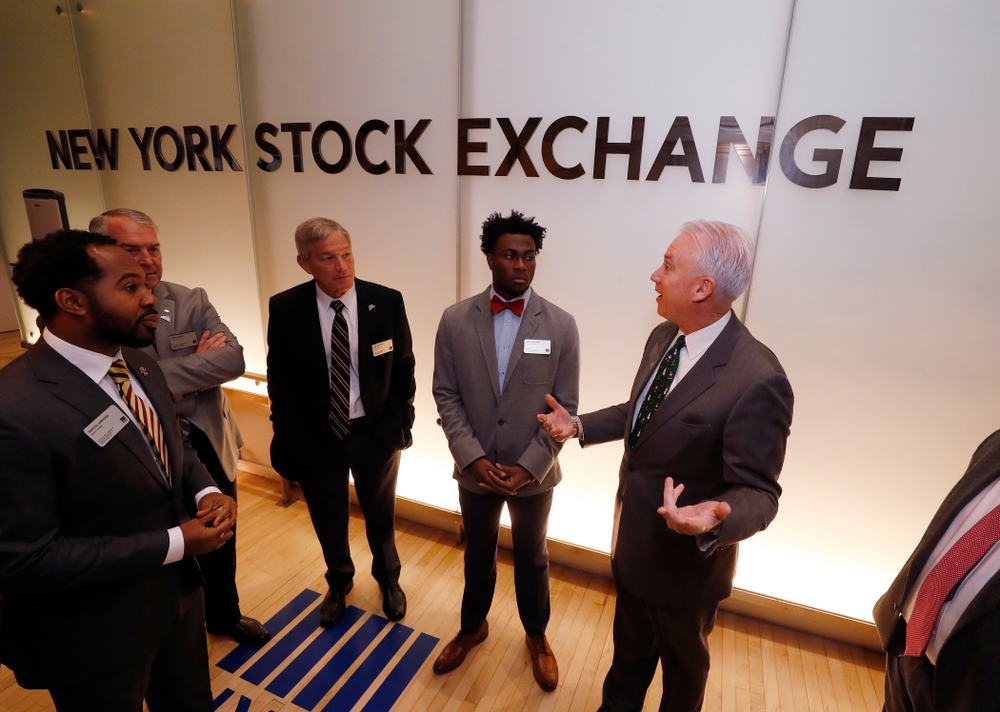 Iowa Hawkeyes linebacker Josey Jewell (43), defensive back Joshua Jackson (15), offensive lineman Sean Welsh (79) and head coach Kirk Ferentz ring the opening bell at the New York Stock Exchange Tuesday, December 26, 2017 in New York. (Brian Ray/hawkeyesports.com)