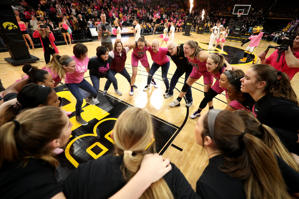 The Iowa Hawkeyes gather with women affected by breast cancer before their game against the Wisconsin Badgers Sunday, February 16, 2020 at Carver-Hawkeye Arena. (Brian Ray/hawkeyesports.com)