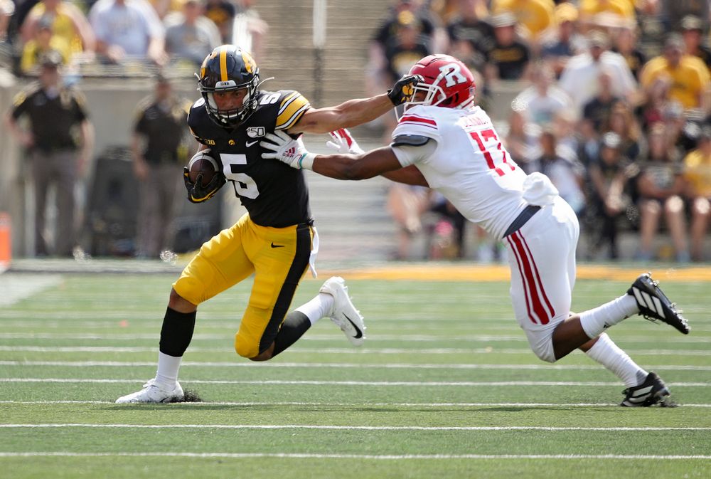 Iowa Hawkeyes wide receiver Oliver Martin (5) stiff-arms a defender after pulling in a pass during the fourth quarter of their Big Ten Conference football game at Kinnick Stadium in Iowa City on Saturday, Sep 7, 2019. (Stephen Mally/hawkeyesports.com)