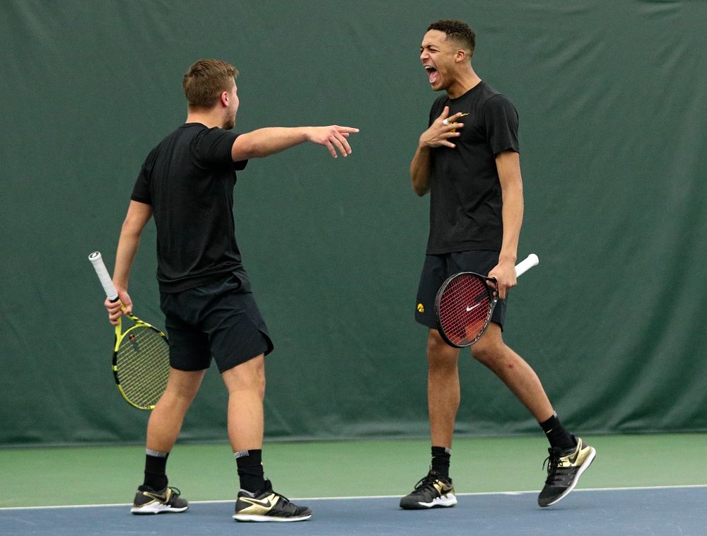 Iowa’s Will Davies (from left) and Oliver Okonkwo celebrate a point during their doubles match at the Hawkeye Tennis and Recreation Complex in Iowa City on Friday, February 14, 2020. (Stephen Mally/hawkeyesports.com)