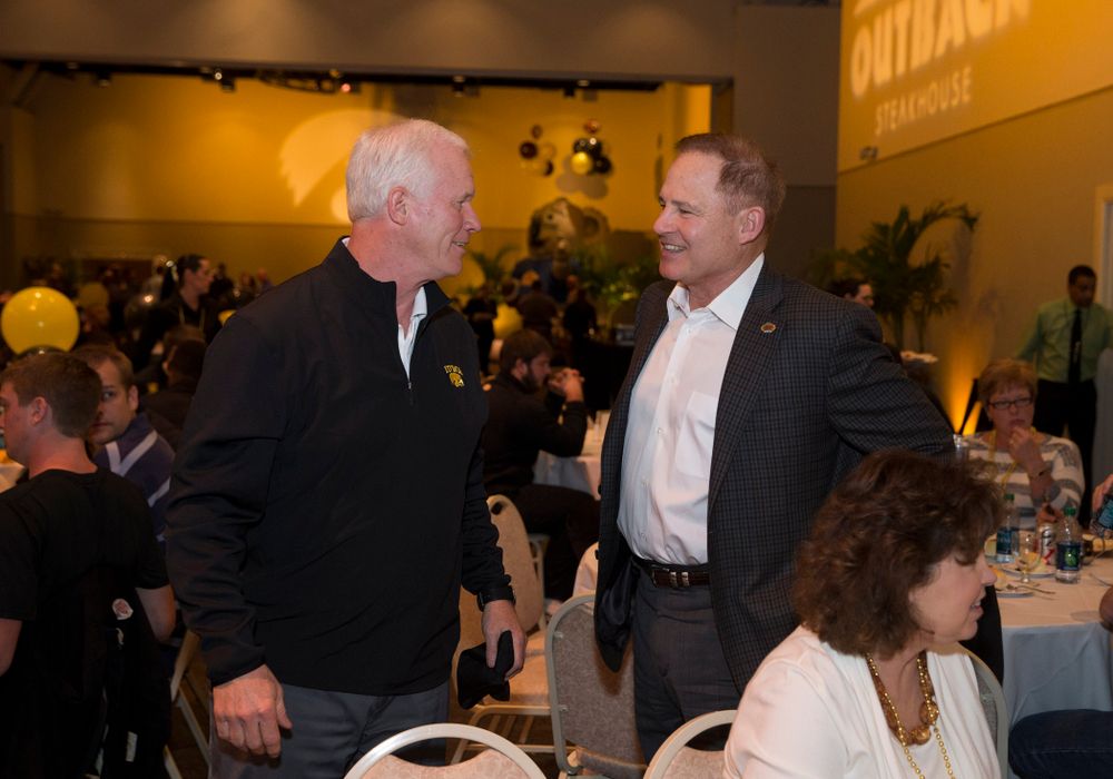 Offensive Line Coach Reese Morgan talks with LSU Tigers Head Coach Les Miles during a team dinner hosted by Outback Steakhouse Thursday, Dec. 26, 2013 in Tampa. (Brian Ray/hawkeyesports.com)